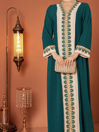 Green kaftan with embroidered lace details for National Day outfit - 70% off using Styli promo code